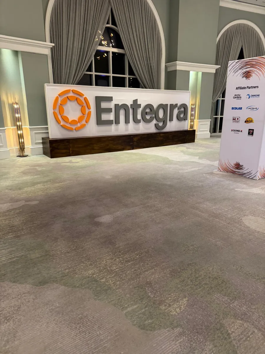 Large freestanding Entegra dimensional logo letters with partner towers in a hotel foyer.