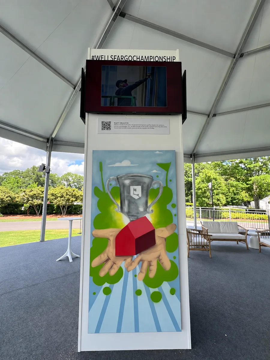 A tall printed Wells Fargo activation tower with an illustrated graphic and a screen header under a tent.